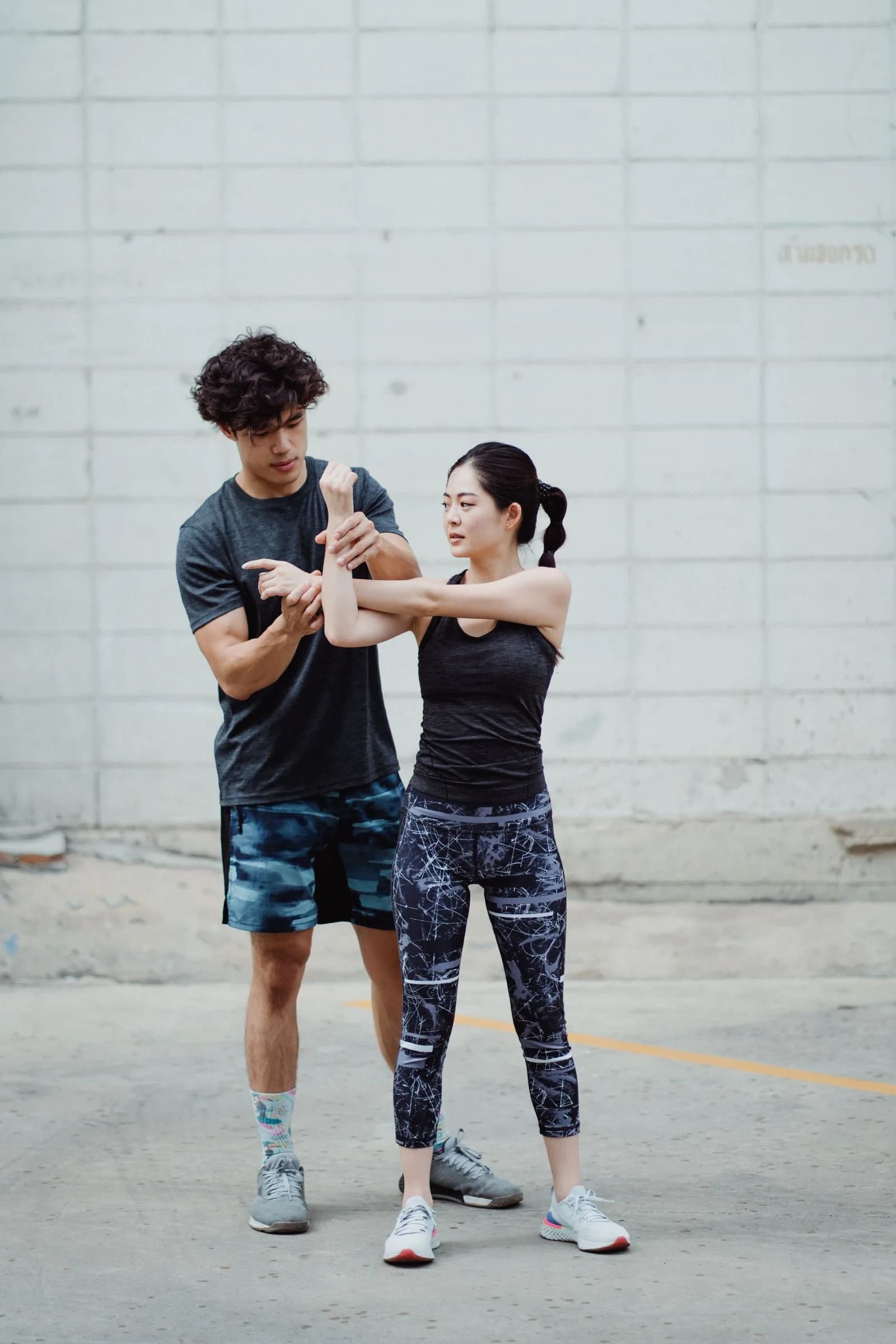 Trainer helping client stretch — Fitness & Wellness marketing by TML Agency