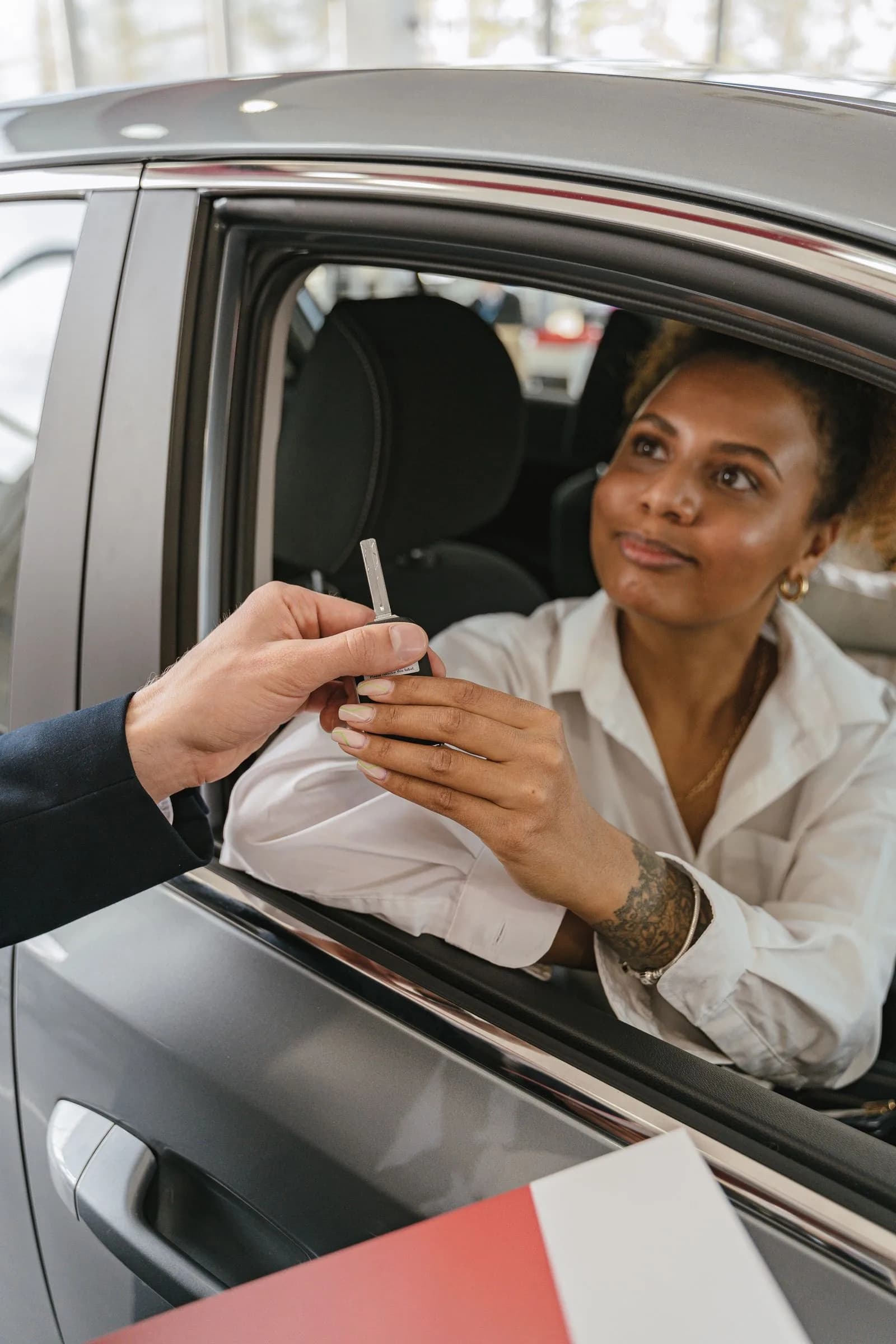 Salesperson handing car keys — Automotive marketing by TML Agency