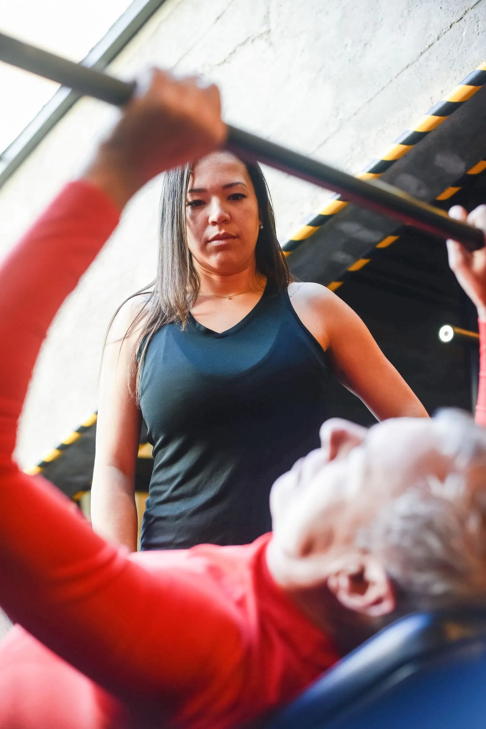 Trainer spotting weightlifter — Gyms & Fitness Centers marketing by TML Agency